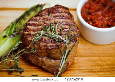 Beautiful Juicy Well Done Steak With Sauce On A Wooden Board