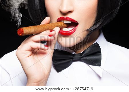 Sexy mafiosi woman smoke with cigar closeup isolated on black
