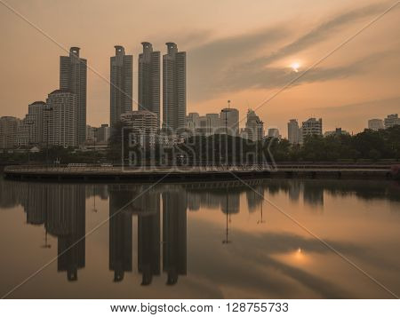 Beauty landscape with sunrise over the park at Bangkok Thailand (Benchakitti Park)