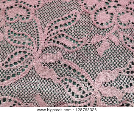 Light pink lace band over a black background