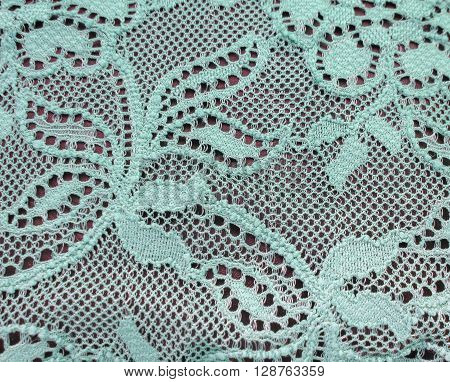 Light green blue lace band over a black background