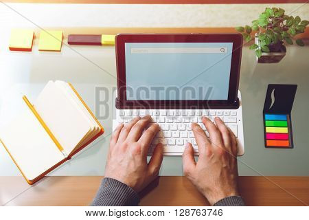 Man sitting at a table, working behind the laptop. Mock up. View from above. Telework concept