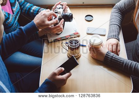 Among friends, sitting at a table taking pictures. top view