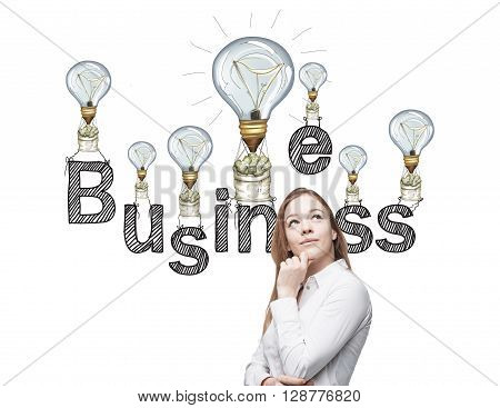 Business idea concept with thoughtful businesswoman and lightbulb air balloons with money sacks