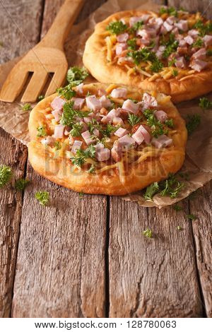 Langos Deep Fried With Cheese And Ham Close-up. Vertical