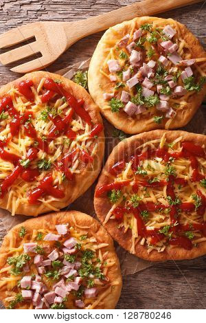 Hot Fried Langos With Cheese, Ketchup And Ham Close-up On The Table. Vertical Top View