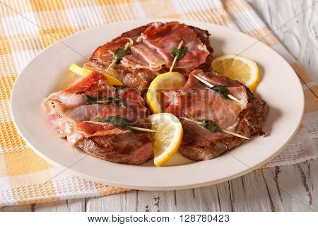 Saltimbocca Veal With Sage, Ham And Slices Of Lemon Close-up. Horizontal