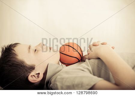 Child Asleep With Little Ball Under Chin