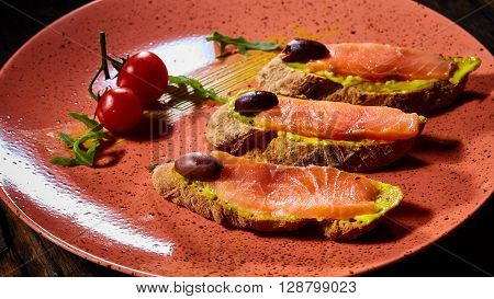 Delicious homemade smoked salmon gluten free canape garnished with tomatoes and olives