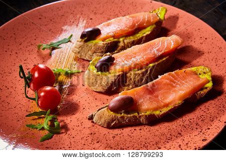Delicious homemade smoked salmon gluten free canape garnished with tomatoes and olives
