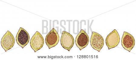 nine gluten free grains (millet, black quinoa, buckwheat, amaranth, teff, sorghum, kaniwa,  and brown rice) - a row of leaf shaped ceramic bowls isolated on white
