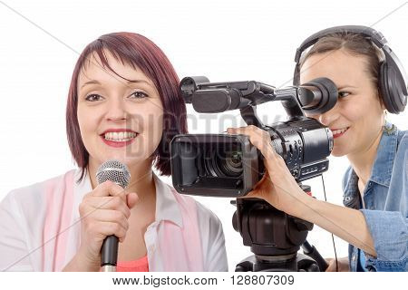 a young woman journalist with a microphone and camerawoman