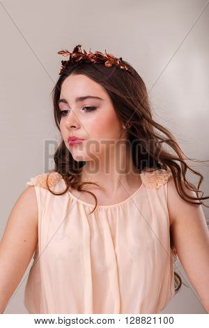 Portrait of a gorgeous brunette on a light background. Chic hair eyes and eyebrows.