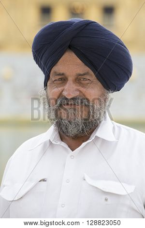 AMRITSAR INDIA - SEPTEMBER 26 2014: Unidentified Sikh man visiting the Golden Temple in Amritsar Punjab India. Sikh pilgrims travel from all over India to pray at this holy site.