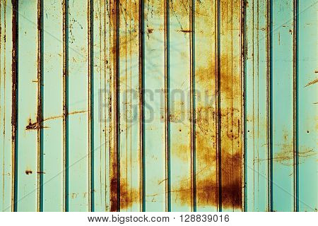 Rusty fence mint color. Mint color background. Rusty metal panel.