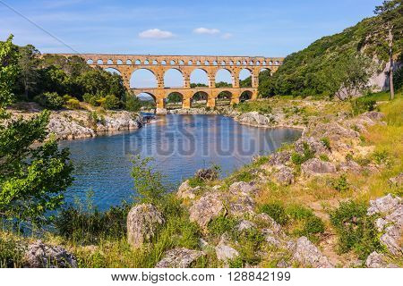 Three-tiered aqueduct Pont du Gard - the highest in Europe.  Provence, spring sunny day. The bridge was built in Roman times on the river Gardon