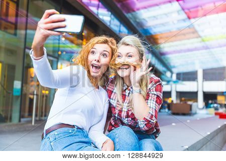 Two Beautiful Women Taking A Funny Selfie
