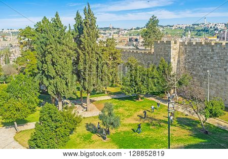 JERUSALEM ISRAEL - FEBRUARY 18 2016: The children plays football in tiny Mishol Hapninim Garden located between New and Damascus Gates on February 18 in Jerusalem.