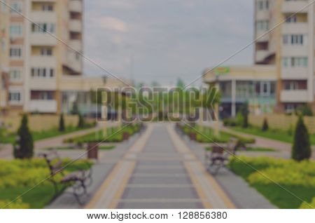 Boke. Blurring background. A new residential complex with green alleys. The park near the house. Residential complex Petrovsky quarter