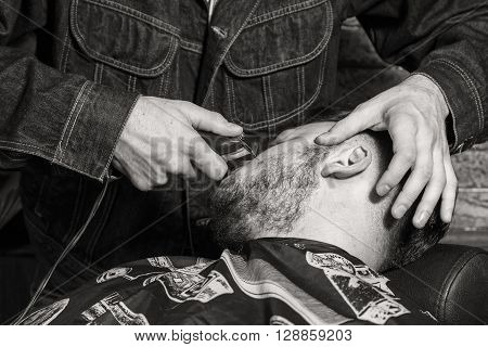 Haircut men Barbershop. Men's Hairdressers; barbers. Barber cuts client with scissors.