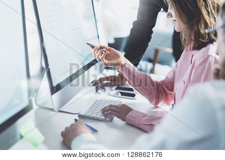 Coworking team process in modern office.Project managers work  idea.Young business crew working with startup studio.Desktop computer table, showing presentation, reflection monitor.Blurred, film effects.