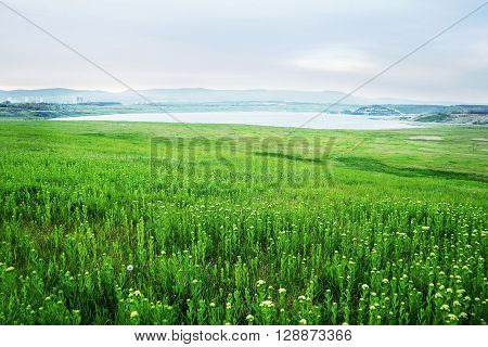 spring evening photo of Lake Most viewed from the verdant fields in North Bohemia landscape