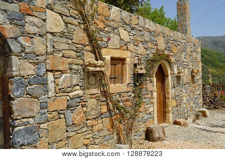 Blue stone Cretan typical house with a vineyard and a window and a wooden door
** Note: Soft Focus at 100%, best at smaller sizes