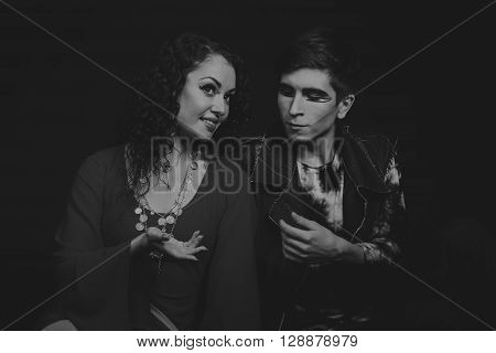 Acting. Man and woman in an interesting way on a dark background.