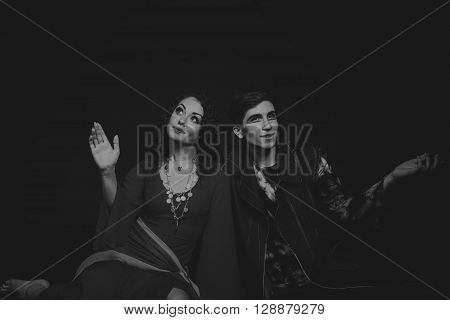 Acting. Man and woman in an interesting way on a dark background.