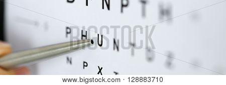 Silver Ballpoint Pen Pointing To Letter In Eyesight Check Table