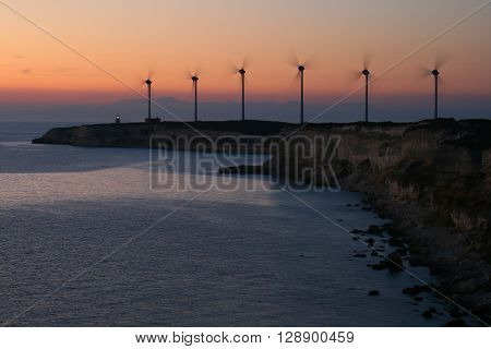 wind farm silhouette with lighthouse near sea