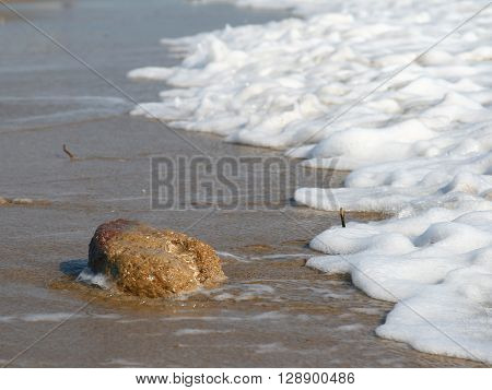 white waves and stone near the sea