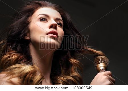 Laying, modeling hair on a round brush.