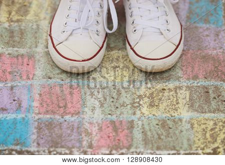 Kid In White Sneakers Stand On Crayon Chalk Drawing