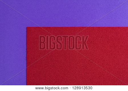 Eva foam ethylene vinyl acetate sponge plush red surface on purple smooth background