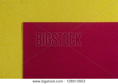 Eva foam ethylene vinyl acetate red surface on lemon yellow sponge plush background