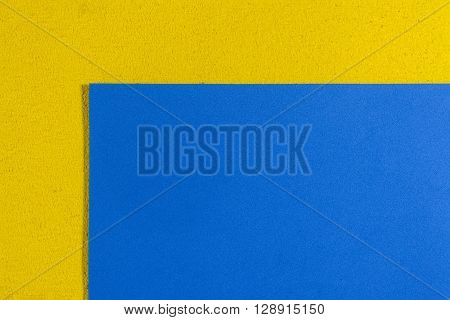 Eva foam ethylene vinyl acetate smooth blue surface on lemon yellow sponge plush background