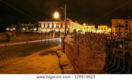 Night hyperlapse time lapse on the historic landmark New Bridge Puente Nuevo of Ronda town in Spain. with running cars across the road and moving people