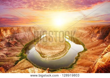 Vivid dramatic sunset over Horseshoe Bend, a famous meander on river Colorado near the town of Page. Arizona, USA