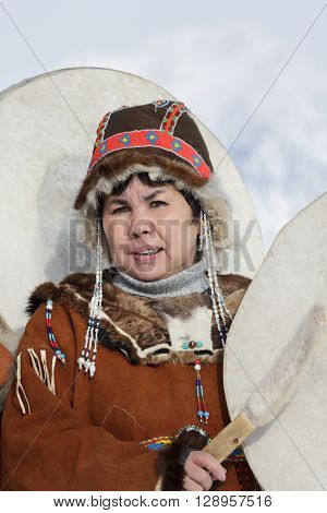 KAMCHATKA PENINSULA RUSSIA - FEB 5 2012: Portrait of woman dressed in Koryak national dress with tambourine. Public concert Koryak National Folklore Dance Group. Russian Far East Kamchatka Region.