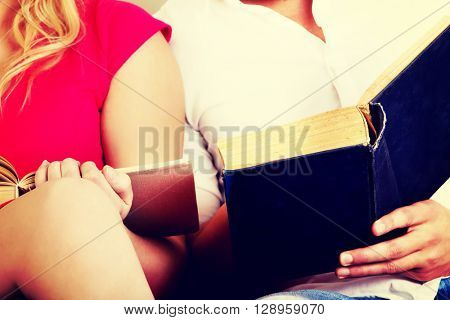 Young couple reading a books together