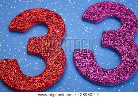 Number thirtythree red purple color over a blue background. Anniversary. Horizontal