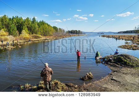 MIDDLE URALS RUSSIA - MAY 5 2016: Many fishermen catch fish in the mouth of the river Kanava during the spring fishing activity. Middle Ural. Russia