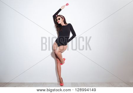 Full length portrait of a charming woman with lollipop posing isolated on a white background