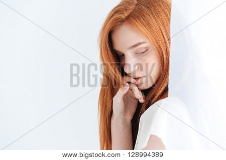 Pretty redhead woman posing on white background