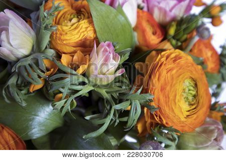 A Wedding Bouquet Of Buttercups, Anemones And Ruscus On The White Background