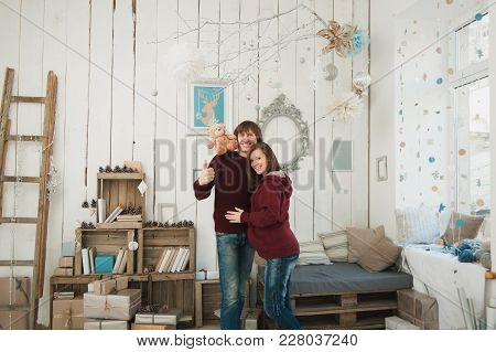 Happy Pregnant Young Woman With Big Belly Tummy, Man In Decor Room. Couple With Taddy Bear. Wife, Hu