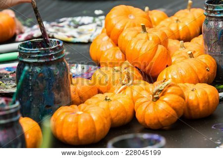 Miniature Pumpkins Sit On Arts And Crafts Table Waiting To Be Painted At Fall Festival.
