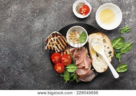 Appetizing Snack With Fried Cheese Haloumi, Olives, Bruschetta, Tomatoes, Olives, Pine Nuts, Prosciu