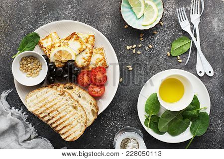 Appetizing Snack With Fried Cheese Haloumi, Olives, Bruschetta, Tomatoes, Olives, Pine Nuts, Prosciu